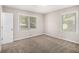 Comfortable bedroom featuring plush carpeting, two windows and neutral paint at 637 Carlouetta Sw Rd, Mableton, GA 30126