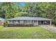 Charming single-story home with a well-maintained lawn and mature trees at 637 Carlouetta Sw Rd, Mableton, GA 30126