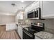 Bright kitchen featuring granite countertops, stainless steel appliances and white cabinets at 637 Carlouetta Sw Rd, Mableton, GA 30126