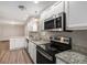 Kitchen featuring stainless steel appliances, white cabinets, and granite countertops at 637 Carlouetta Sw Rd, Mableton, GA 30126