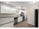 Modern kitchen with white cabinets, stainless steel appliances, and granite countertops at 637 Carlouetta Sw Rd, Mableton, GA 30126