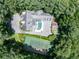 Aerial view of the sprawling property with a pool, tennis court, guest house, and lush landscaping at 1016 Old Powers Ferry Rd, Atlanta, GA 30327