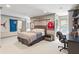 A gray bedroom with sports decor, a bed, a desk, and lots of storage at 1016 Old Powers Ferry Rd, Atlanta, GA 30327