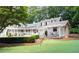 Backyard with a guest house, putting green, pool, and porch for elegant outdoor living and recreation at 1016 Old Powers Ferry Rd, Atlanta, GA 30327