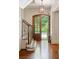 Bright foyer showcasing a staircase, hardwood floors, natural light, and paneled walls at 1016 Old Powers Ferry Rd, Atlanta, GA 30327