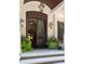 Elegant front entry features a wood door, stone steps and well-manicured landscaping at 1016 Old Powers Ferry Rd, Atlanta, GA 30327