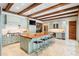 A gourmet kitchen featuring a large island, wood beams, and a modern appliance package at 1016 Old Powers Ferry Rd, Atlanta, GA 30327