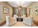 Sitting room with custom bookshelves, hardwood floors, and lots of natural light at 1016 Old Powers Ferry Rd, Atlanta, GA 30327