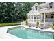 Backyard pool with sun loungers on the pool deck and a covered porch overlooking the area at 1016 Old Powers Ferry Rd, Atlanta, GA 30327