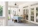 Inviting covered porch featuring a ceiling fan and a dining area with french doors at 1016 Old Powers Ferry Rd, Atlanta, GA 30327