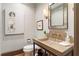 A minimalist powder room featuring a unique sink, decorative mirror, and subtle lighting at 1016 Old Powers Ferry Rd, Atlanta, GA 30327