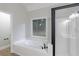 Bright bathroom with a soaking tub, separate glass shower, and a large window overlooking the backyard at 3807 Lance Bluff Ct, Duluth, GA 30097