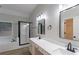 Bathroom featuring a double sink vanity, walk-in shower with black trim, and a separate closet at 3807 Lance Bluff Ct, Duluth, GA 30097