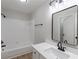 Updated bathroom with a single sink vanity, modern fixtures, and a shower-tub combination at 3807 Lance Bluff Ct, Duluth, GA 30097