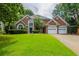 Charming two-story brick home with a well-manicured lawn and an attached two-car garage at 3807 Lance Bluff Ct, Duluth, GA 30097