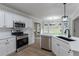 Modern kitchen features white cabinets, stainless steel appliances, and a sleek countertop at 3807 Lance Bluff Ct, Duluth, GA 30097