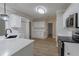 Bright kitchen with white cabinetry, stainless steel appliances, and hardwood floors at 3807 Lance Bluff Ct, Duluth, GA 30097
