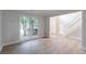 Spacious living room with large window, hardwood floors, and a staircase leading upstairs at 3807 Lance Bluff Ct, Duluth, GA 30097