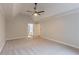 Spacious main bedroom with a ceiling fan, neutral walls, and an ensuite bathroom at 3807 Lance Bluff Ct, Duluth, GA 30097