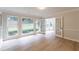 Sunroom with hardwood floors, large windows, and French doors leading to an adjacent room at 3807 Lance Bluff Ct, Duluth, GA 30097