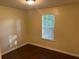 Cozy bedroom featuring wood floors and natural light from a window at 796 Cohran Store Rd, Douglasville, GA 30134