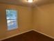 Comfortable bedroom with wood-look floors and a bright window overlooking the outdoors at 796 Cohran Store Rd, Douglasville, GA 30134