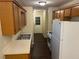 Galley kitchen with wooden cabinets, laminate countertops, and essential appliances at 796 Cohran Store Rd, Douglasville, GA 30134