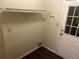 Functional laundry area with shelving and access to the exterior at 796 Cohran Store Rd, Douglasville, GA 30134