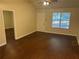 Bright living room with wood floors, large windows, and neutral walls perfect for relaxation at 796 Cohran Store Rd, Douglasville, GA 30134