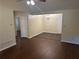 Open living space with wood floors, a ceiling fan, and a dining area with a chandelier at 796 Cohran Store Rd, Douglasville, GA 30134