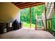 Back patio with adjacent stairway overlooking a lush, green backyard at 8040 Banks Mill Rd, Douglasville, GA 30135