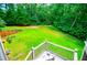 Beautiful backyard with wooden retaining wall and lush green grass at 8040 Banks Mill Rd, Douglasville, GA 30135