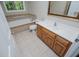 Bathroom featuring a vanity, tub and shower combination with tile surround, and tile flooring at 8040 Banks Mill Rd, Douglasville, GA 30135
