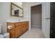 Bathroom featuring vanity with marble countertop, tile flooring, and large mirror at 8040 Banks Mill Rd, Douglasville, GA 30135