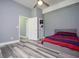 Bedroom featuring a bed with red and blue blankets, grey walls, and light colored floors at 8040 Banks Mill Rd, Douglasville, GA 30135