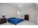 Cozy bedroom with a blue bedspread, neutral walls, and carpeted floor at 8040 Banks Mill Rd, Douglasville, GA 30135