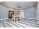 Dining area features light grey walls, hardwood floors, modern lighting, and a table with chairs at 8040 Banks Mill Rd, Douglasville, GA 30135