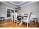 Elegant dining room featuring a rustic table, decorative lighting, and hardwood flooring at 8040 Banks Mill Rd, Douglasville, GA 30135