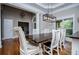 Open dining space with hardwood floors, stylish lighting, and views of the outside at 8040 Banks Mill Rd, Douglasville, GA 30135