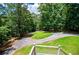 Spacious, circular driveway lined with green grass and surrounded by mature trees at 8040 Banks Mill Rd, Douglasville, GA 30135