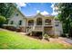 Charming two-story home with a welcoming front porch and a lush green lawn at 8040 Banks Mill Rd, Douglasville, GA 30135