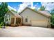Charming home with a two-car garage and a basketball hoop next to the driveway at 8040 Banks Mill Rd, Douglasville, GA 30135