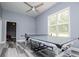 Large game room featuring a ping pong table, ceiling fan, large window, and light grey walls and floors at 8040 Banks Mill Rd, Douglasville, GA 30135