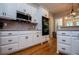 A spacious kitchen features white cabinetry, stainless steel appliances and double ovens at 8040 Banks Mill Rd, Douglasville, GA 30135