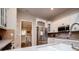 A bright kitchen features stainless steel appliances, granite countertops and modern cabinetry at 8040 Banks Mill Rd, Douglasville, GA 30135