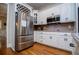 Updated kitchen with white cabinets, stainless steel appliances, and hardwood flooring at 8040 Banks Mill Rd, Douglasville, GA 30135