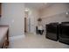 Functional laundry room featuring modern washer/dryer and utility sink at 8040 Banks Mill Rd, Douglasville, GA 30135