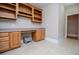 Large laundry area with wooden cabinets, desk, counter space, and modern appliances at 8040 Banks Mill Rd, Douglasville, GA 30135