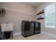 Well-equipped laundry room with sink, modern appliances, and ample storage at 8040 Banks Mill Rd, Douglasville, GA 30135