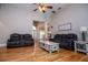 Spacious living room featuring hardwood floors, ceiling fan and large furniture at 8040 Banks Mill Rd, Douglasville, GA 30135